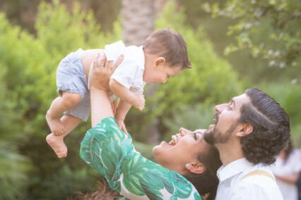 man and woman holding baby