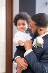 groom holding kid