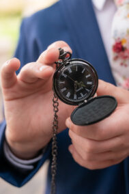 man holding pocket watch