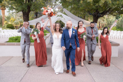 bride and groom next to wedding party