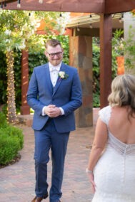 groom watching bride walk down the aisle