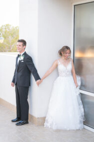 bride and groom holding hands