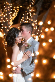 bride and groom surrounded by lights