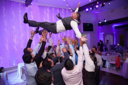man on dance floor getting tossed into air