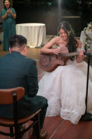 bride playing guitar for groom