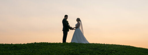 bride and groom on hill