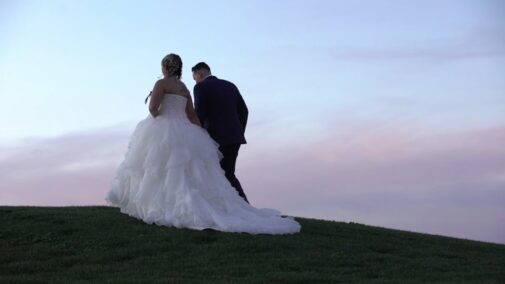 bride and groom on hill